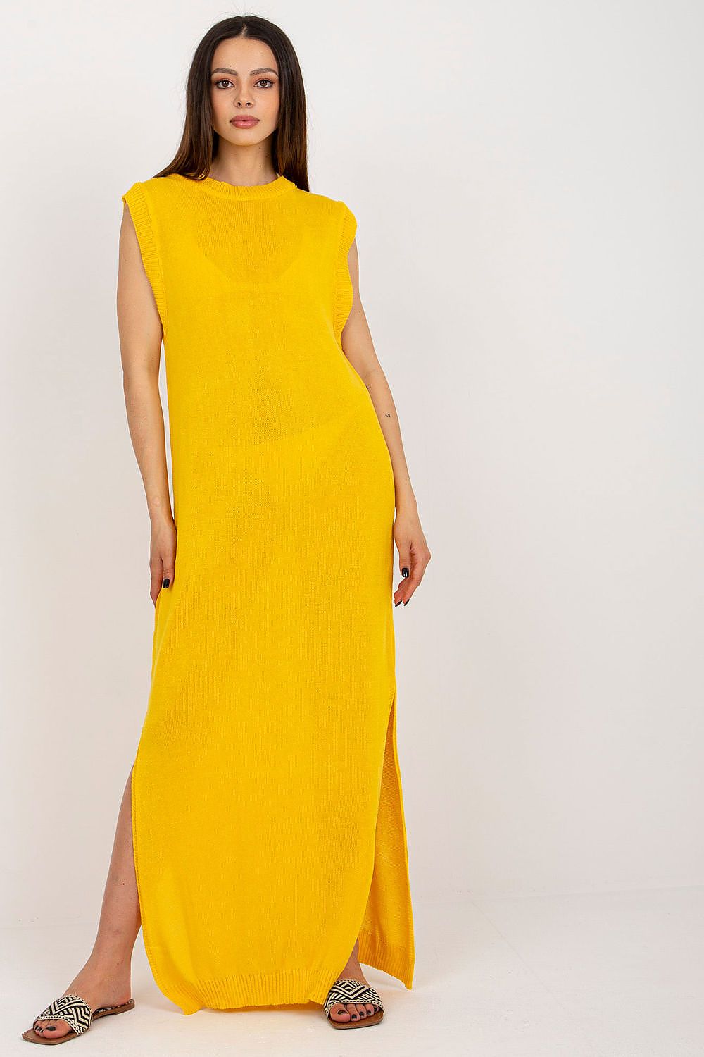 Luxurious long knit beach dress by Badu featuring decorative slits, perfect for elegant summer outings.