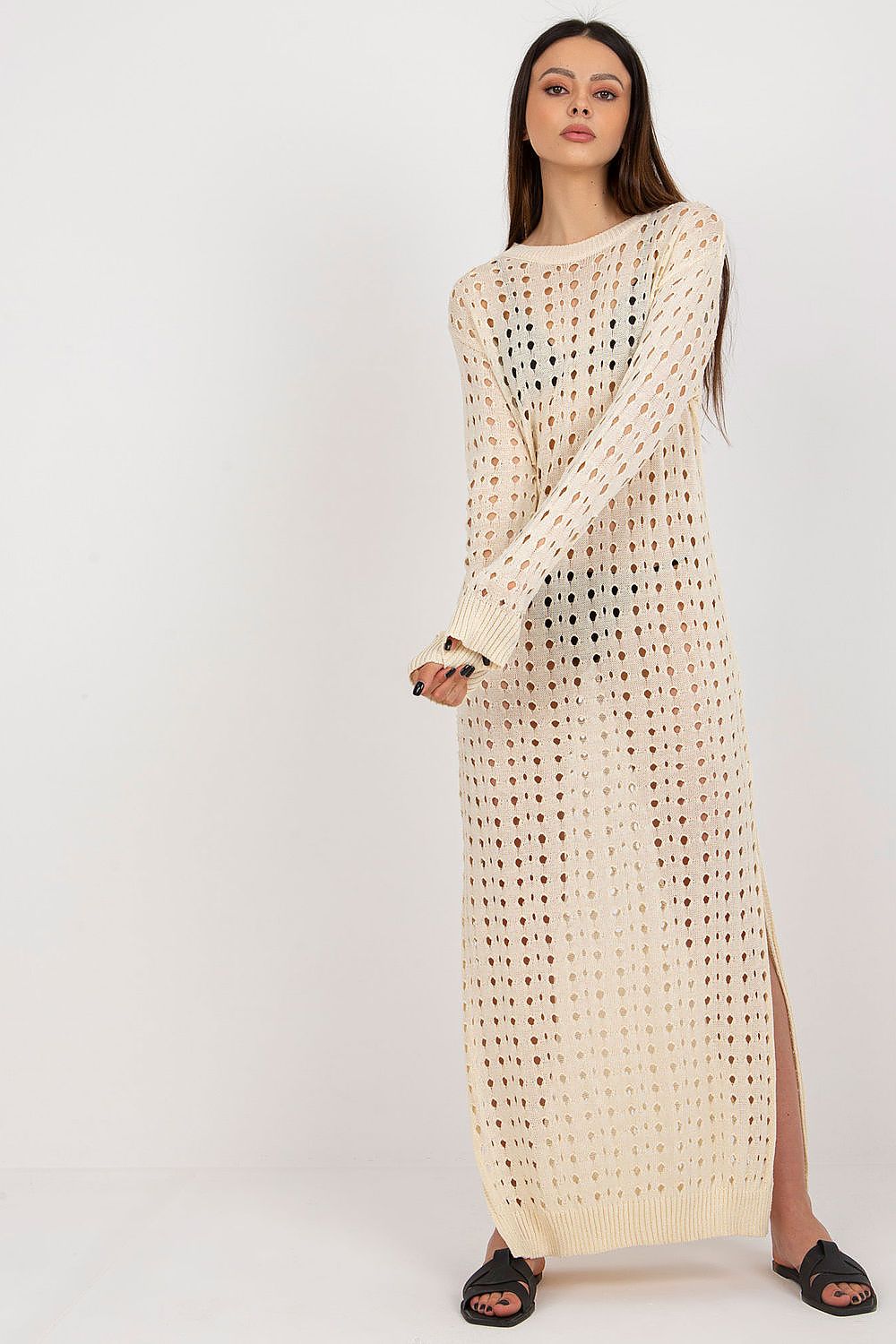Elegant Badu openwork long knit beach dress featuring decorative slits and long sleeves, perfect for a luxurious summer outing.