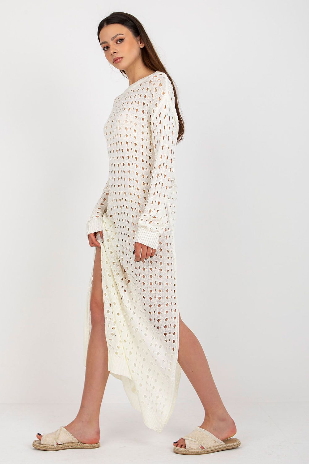 Badu Openwork Long Knit Beach Dress draped elegantly showing decorative side slits, perfect for creating a glamorous beach look.