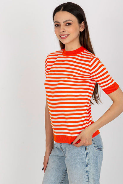 Stylish model showcasing the vibrant knitted blouse with short sleeves and round neckline by Badu.