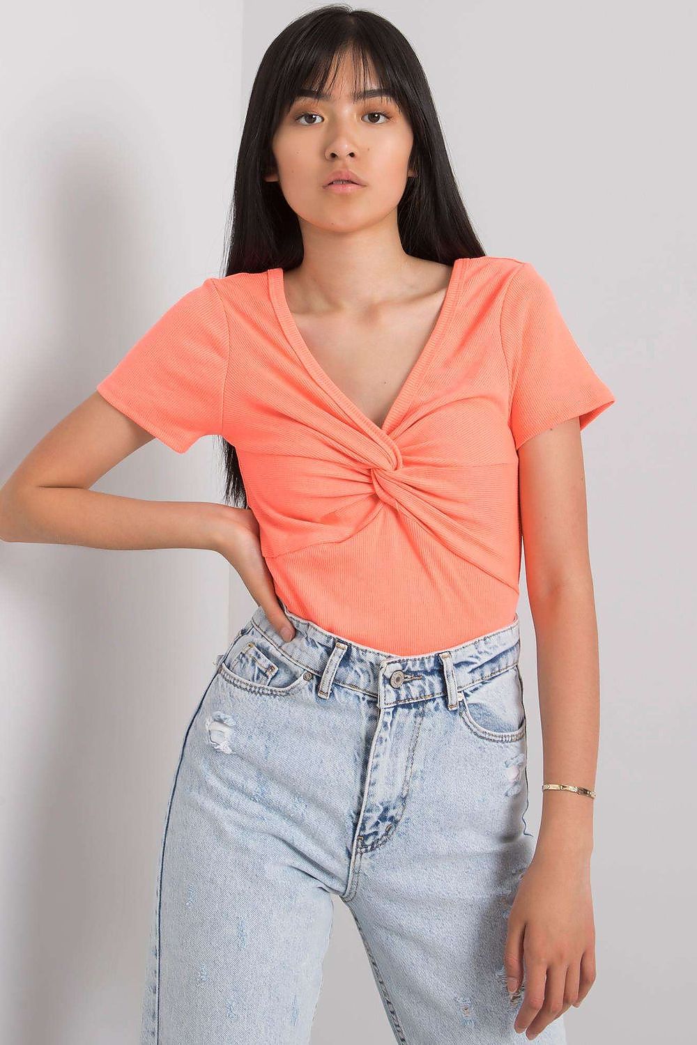 Model wearing the luxurious Calben short sleeve blouse with heart neckline, demonstrating its chic style and comfort in a fashionable outfit.