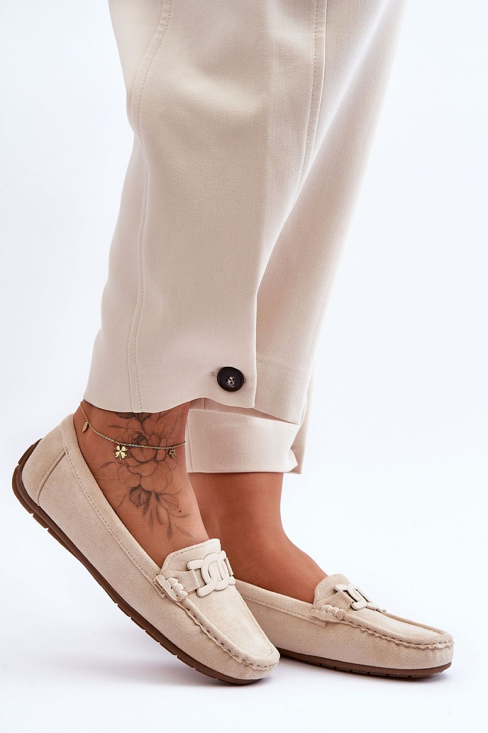 Close-up view of Step in Style women's eco-suede moccasins showcasing the intricate decorative detail and comfortable artificial leather footbed.