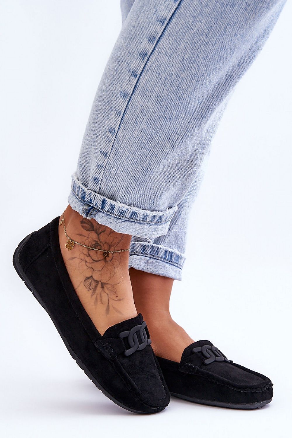 Stylish display of Step in Style women's eco-suede moccasins on a luxurious surface, highlighting the non-slip sole and plush interior for all-day comfort.