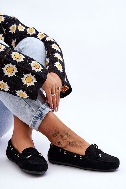 Display of various sizes of women's eco-suede moccasins with decorative bow from Step in Style, emphasizing luxury and style.