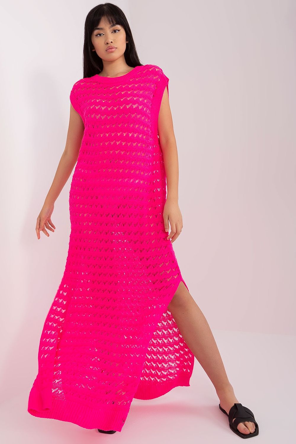 Luxury openwork long knit beach dress by Badu featuring decorative side slits, perfect for chic summer outings.