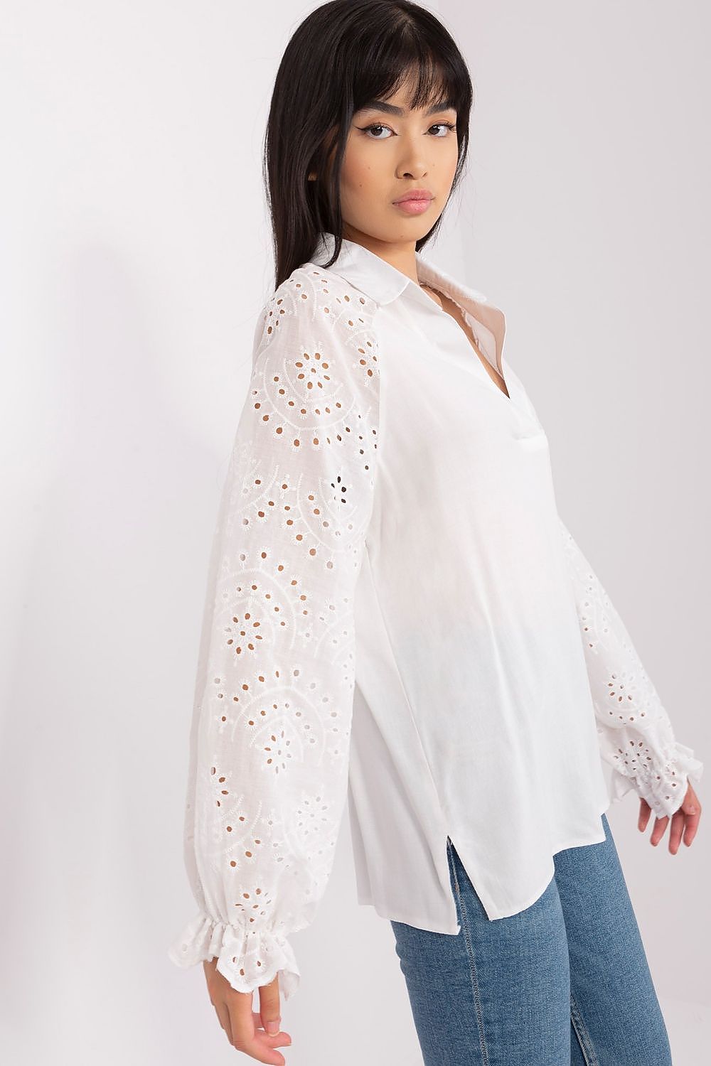 Model wearing the elegant long-sleeved openwork blouse by Lakerta, styled for a chic and timeless fashion statement.
