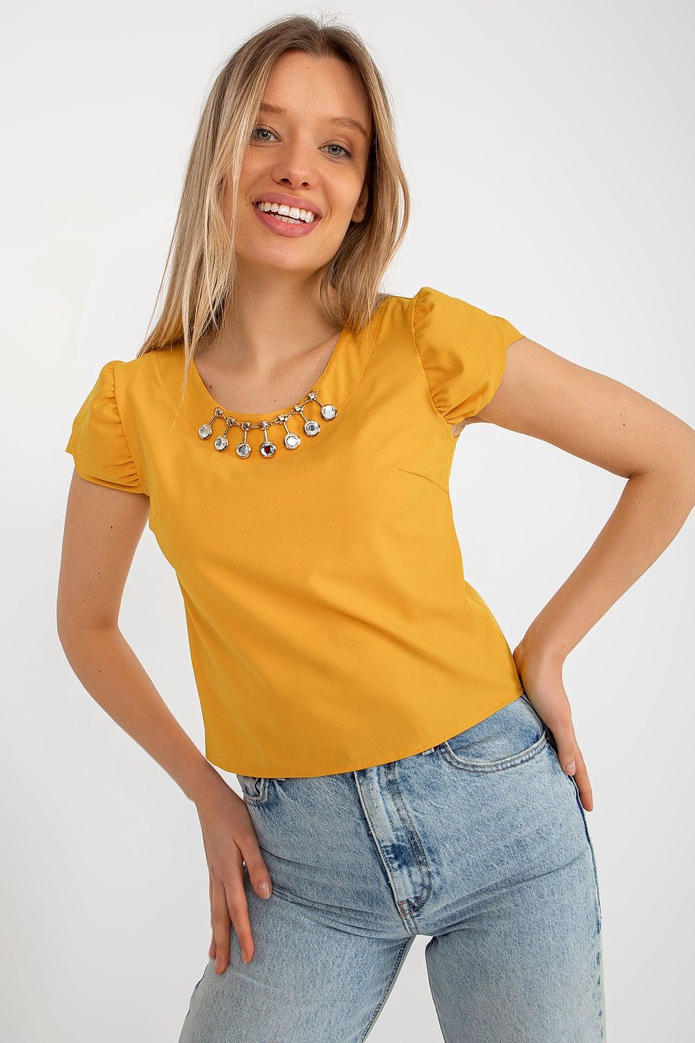 Stylish Lakerta blouse with delicate short sleeves and refined round neckline, perfect for elegant occasions.