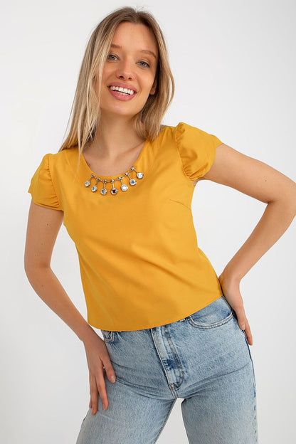 Stylish Lakerta blouse with delicate short sleeves and refined round neckline, perfect for elegant occasions.