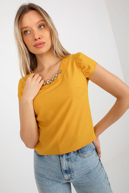 Elegant Lakerta blouse with short sleeves and round neckline featuring a stunning jewelry embellishment, perfect for luxury fashion enthusiasts.