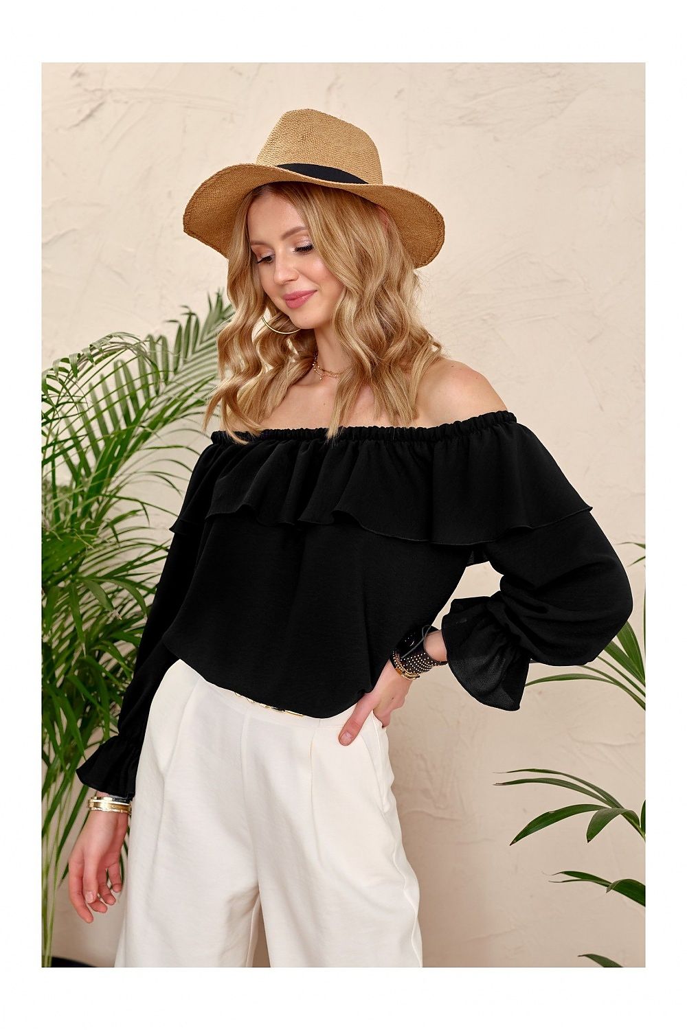 Model wearing Roco Fashion's Spanish ruffle blouse with open shoulders, perfect for stylish and sporty ensembles.