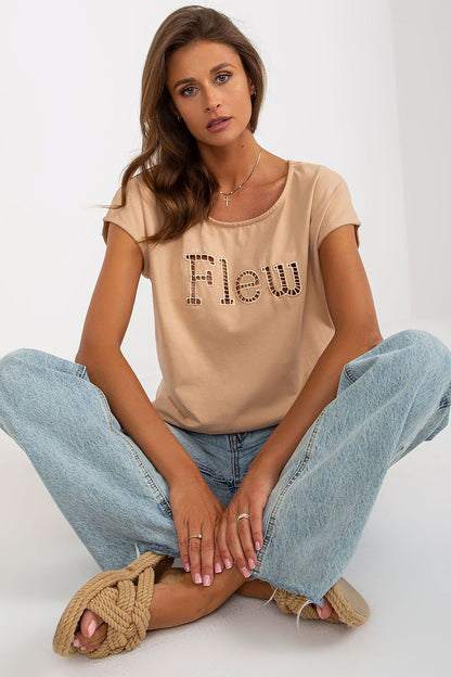 Luxury women's casual cut t-shirt in beige featuring decorative cut-out inscription 'Flew', designed by Fancy. Styled with loose denim jeans for an effortless chic look.