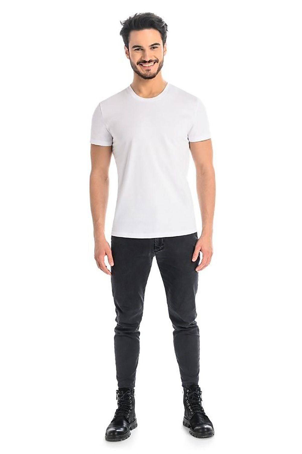 Stylish male model sporting a timeless white T-shirt by Teyli, paired with dark slim-fit trousers, ideal for casual outings.