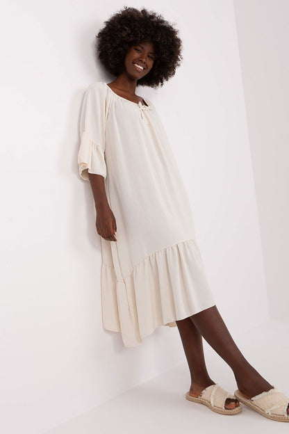 Stylish summer dress by Italy Moda, showcasing a frill design on the sleeves and hem for a sophisticated look.