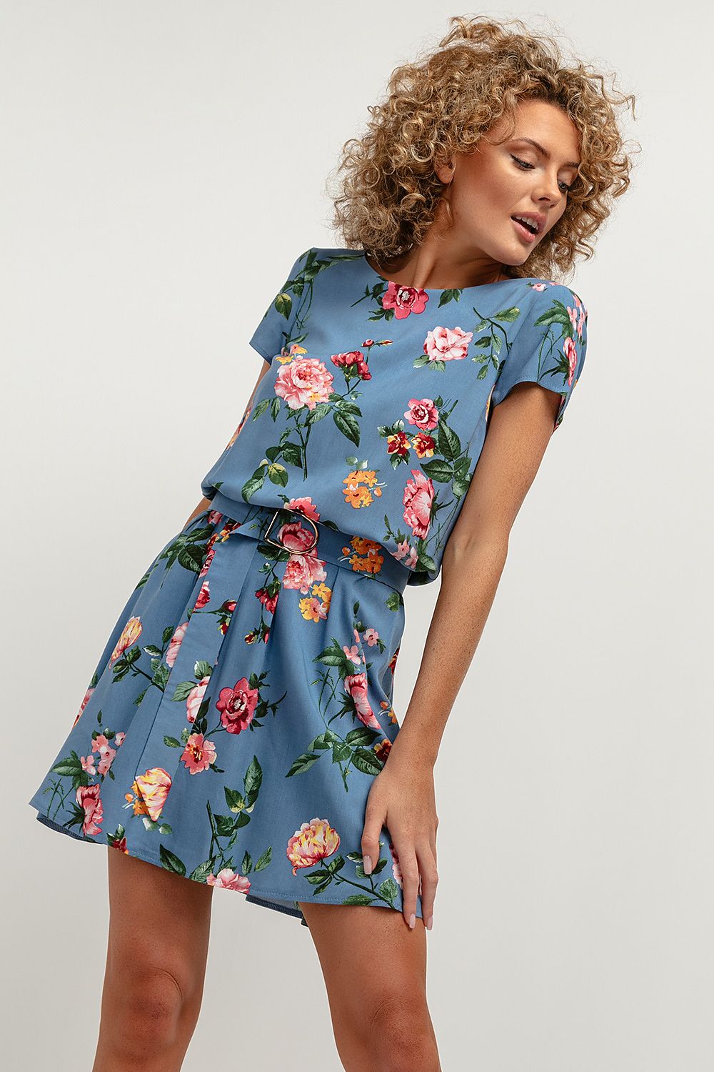 Back view of the Tessita Floral Daydress showcasing the deep V-shaped neckline and tied belt accentuating the waist.