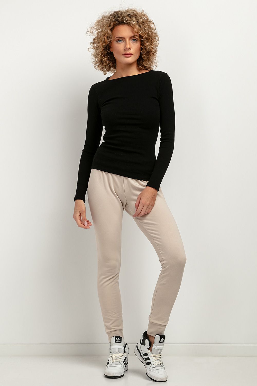 Close-up texture of the luxurious ribbed fabric used in the Tessita fitted blouse, highlighting its soft cotton and spandex blend.