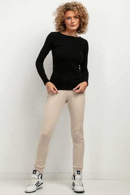 Model showcasing the elegant Tessita fitted long-sleeve ribbed blouse, demonstrating its flattering silhouette on various body types.