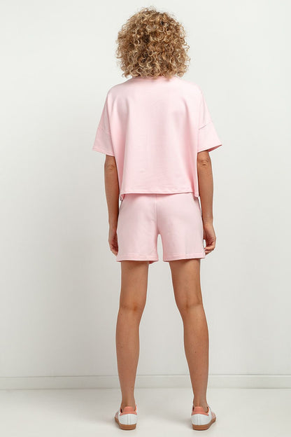 Detail of Tessita Short Sleeve Blouse highlighting the elegant hems and attached sleeves, perfect for versatile ensembles.