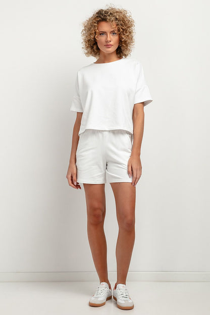 Sleek high-waisted shorts by Tessita with unique waist crease and spacious pockets, embodying effortless summer chic.