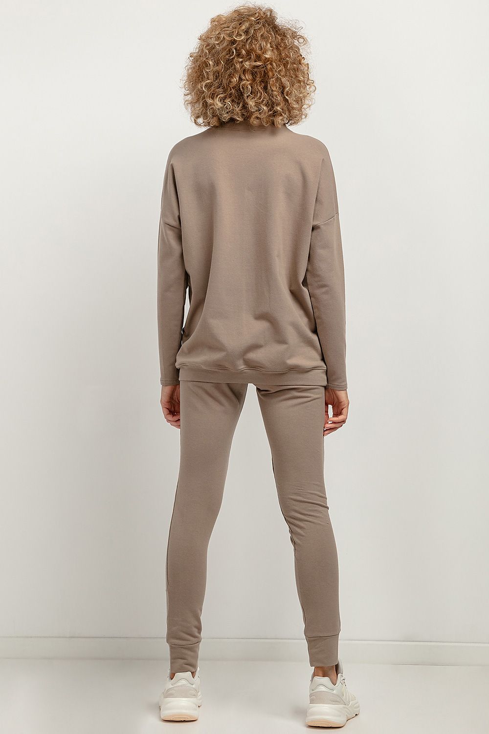 Tessita tracksuit trousers modelled by an elegant figure, demonstrating the flattering silhouette and soft knit material.