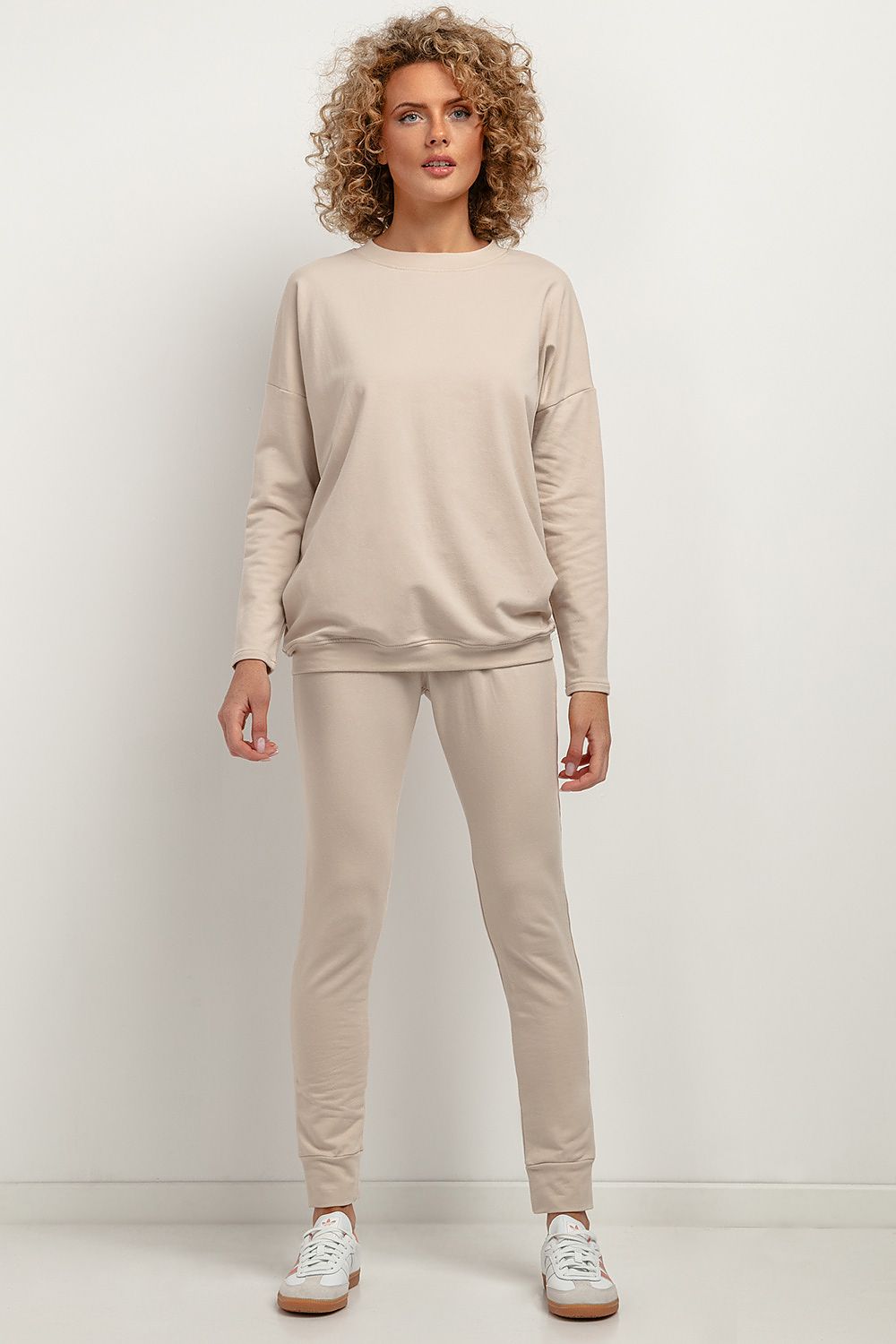 Tessita tracksuit trousers displayed in a luxurious setting, highlighting their elegant design and practical features.