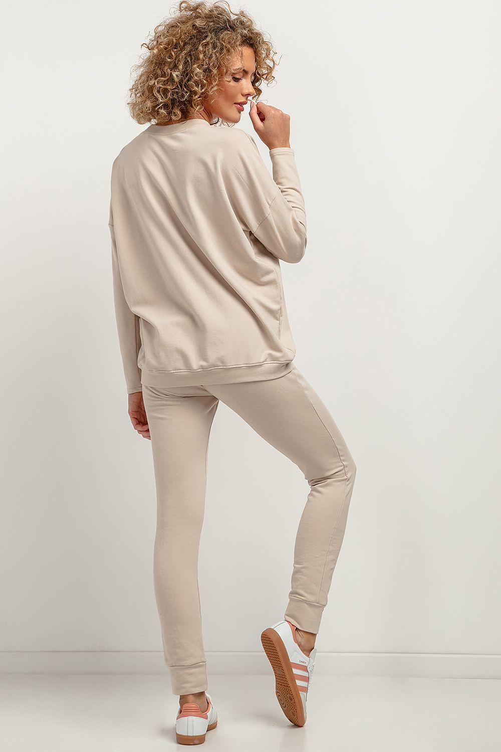 Elegant Tessita soft knit trousers modelled in a lifestyle context, showcasing versatility and comfort in fashion.