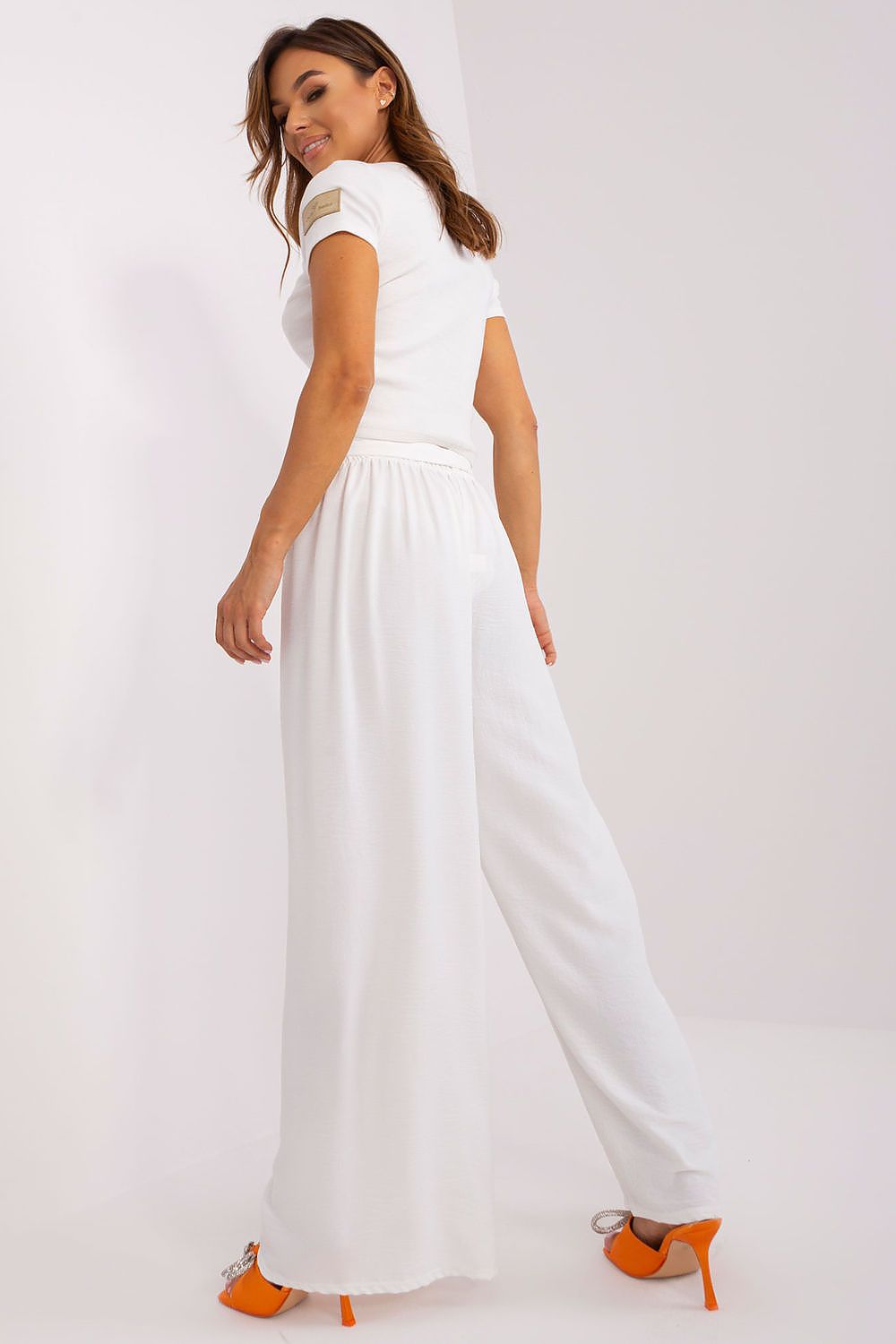 Feminine luxury summer trousers from Och Bella, featuring an alluring wide leg silhouette and tailored waist binding for a perfect ensemble.