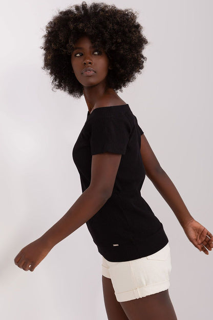 Sophisticated model wearing the elegant short sleeve blouse by Relevance, made from a rich cotton and spandex blend, tailored perfectly for EU size 0.