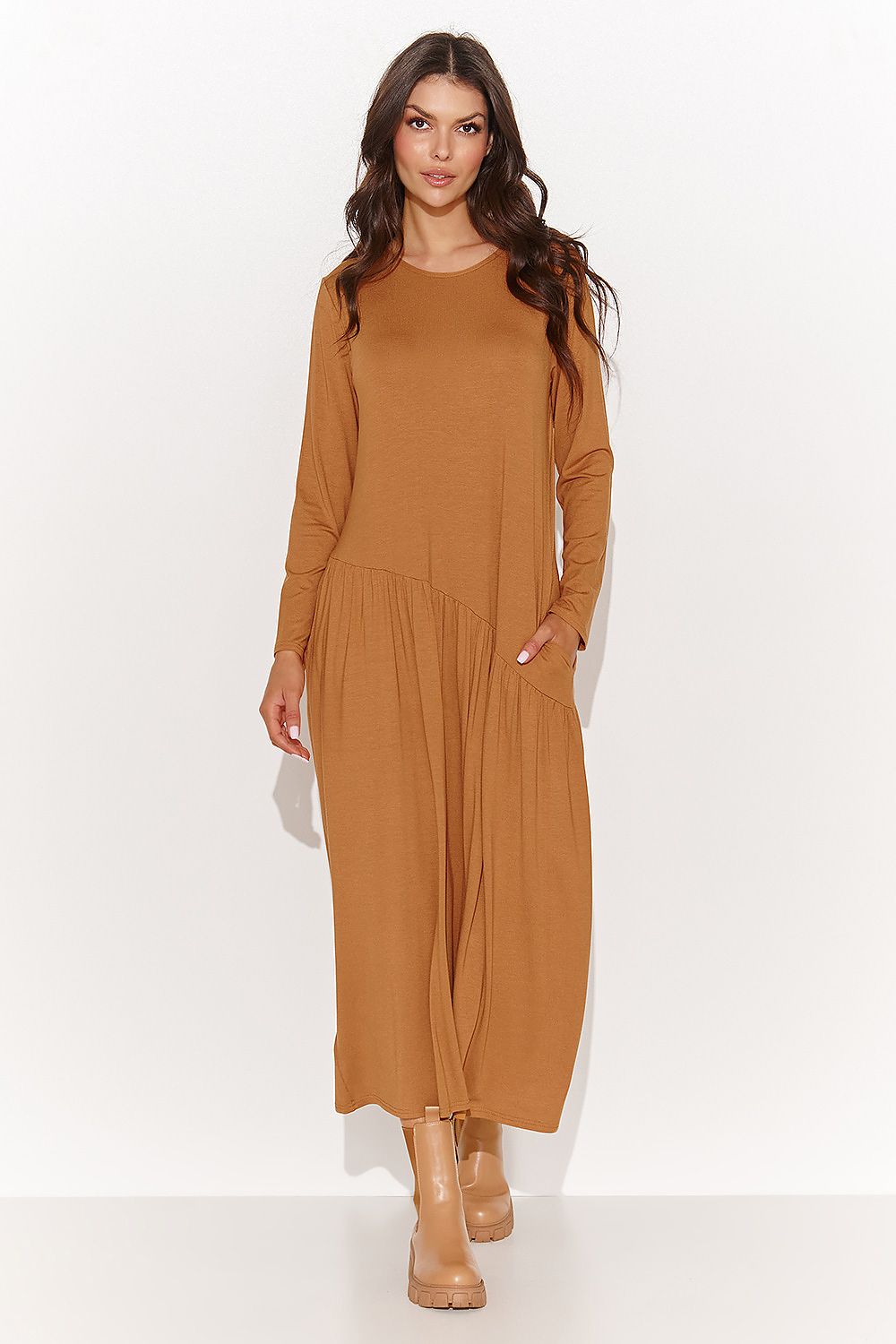 Stunning Numinou Maxi Dress in Camel, featuring long sleeves and convenient slip pockets, ideal for chic day-to-night styling.