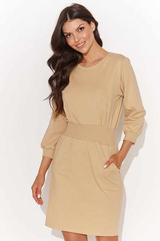 Elegant Numinou knee-length casual daydress in sand colour made from soft sweatshirt knit fabric, featuring stylish side pockets.