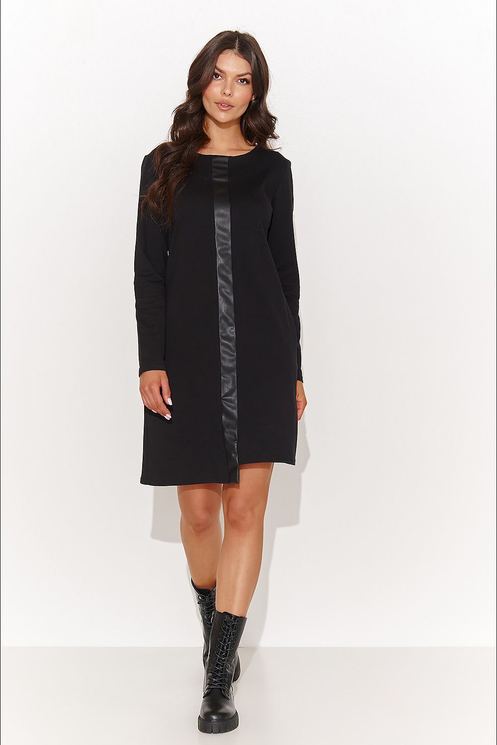 Close-up view of the eco-leather details on an elegant black tracksuit dress by Numinou, showcasing its luxurious materials and sophisticated design.