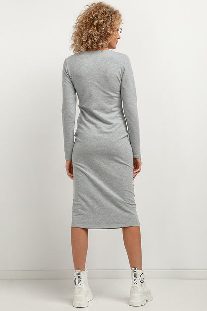 Luxurious Tessita soft knit midi dress elegantly draped, perfect for any occasion with a sophisticated boat neckline.