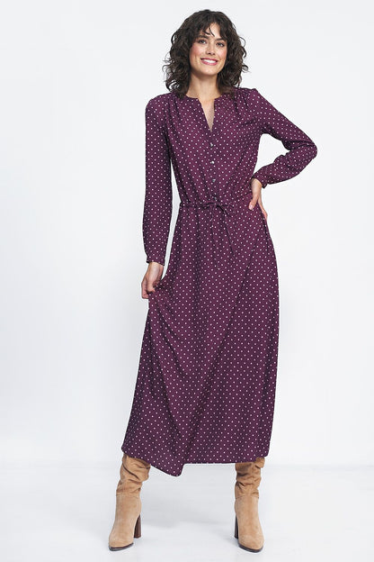 Back view of the long dress with peas print by Nife, emphasizing its graceful draping and flattering fit.