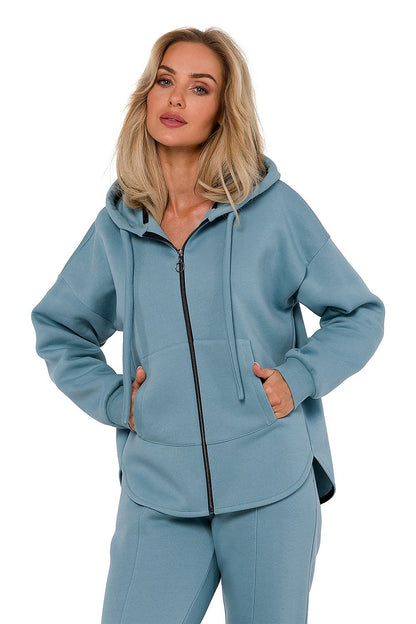 Model showcasing the refined silhouette of the women's knitted sweatshirt by Moe with a kangaroo pocket.