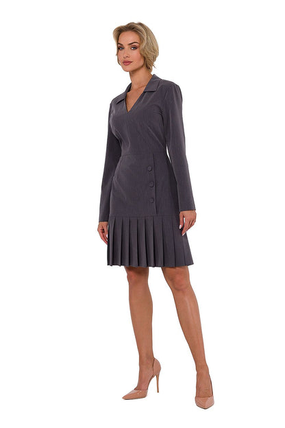 Elegant long sleeve Moe dress featuring a flattering V neckline, decorative buttons, and intricate pleating at the hem, designed and made in Poland.