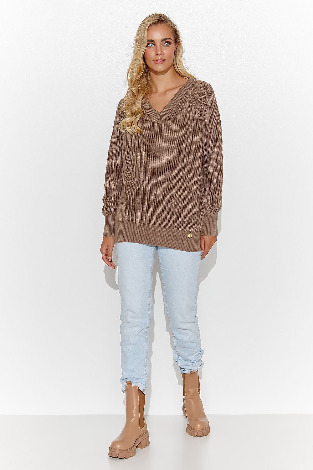 Stylish Makadamia women's sweater displayed on a model, highlighting its elegant heart neckline, gold tinsel detail, and versatile styling options for day to night.