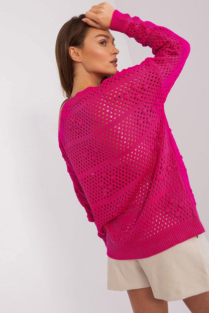 Stylish Badu Openwork Sweater styled with casual chic, highlighting its long sleeves and breathable openwork pattern, an essential piece for contemporary luxury wardrobes.