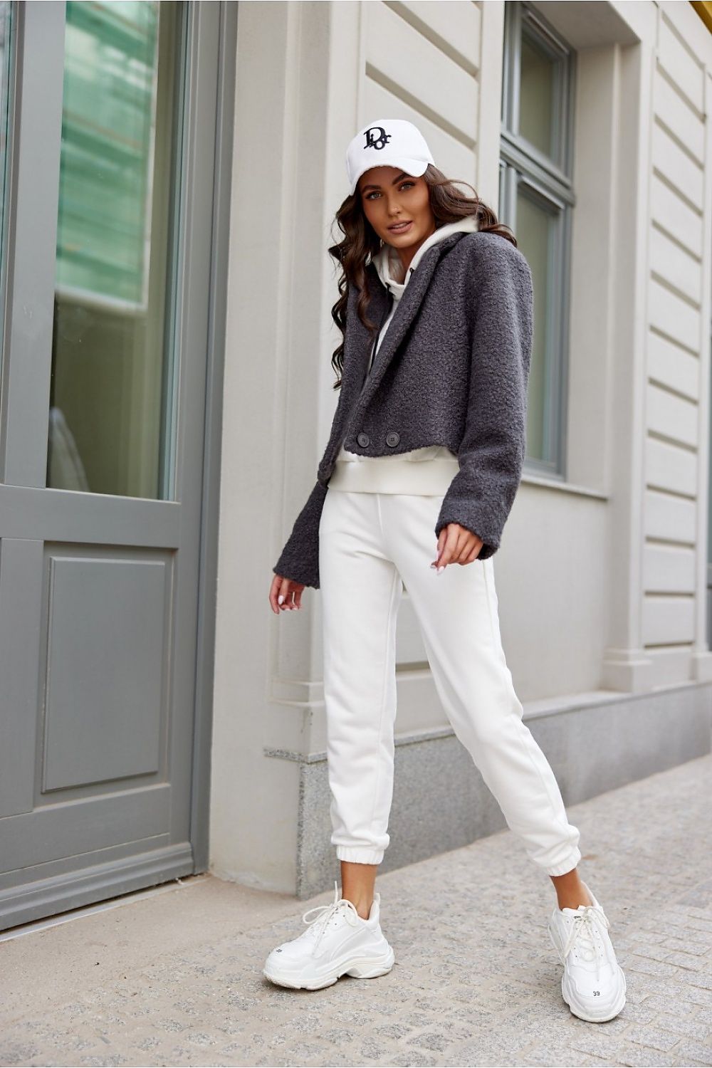 Detail of Roco Fashion's short jacket showcasing the elegant lining and sophisticated button closure.