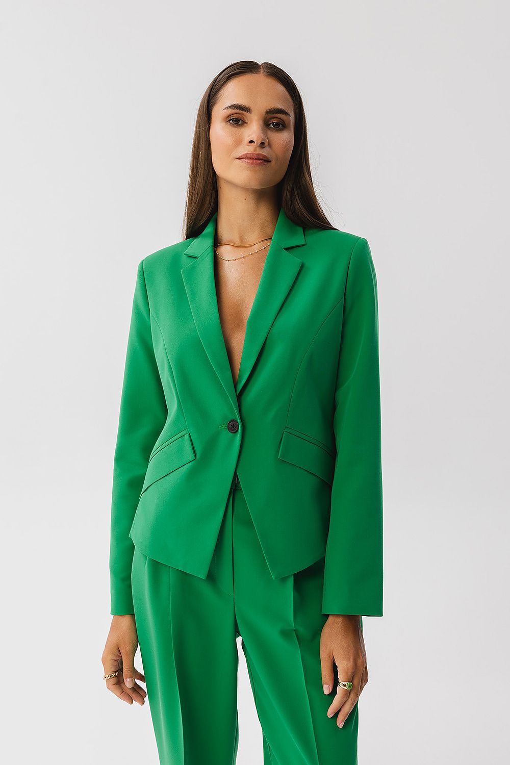 Stylove Asymmetrical Elegant Jacket in a sophisticated setting, highlighting its chic single button closure and imitation pocket, a perfect piece for luxury fashion.