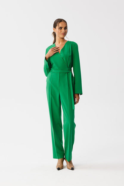 Stylove elegant jumpsuit featuring an envelope neckline and statement waist belt, designed for modern luxury, showcasing high-quality fabric and sophisticated detailing.