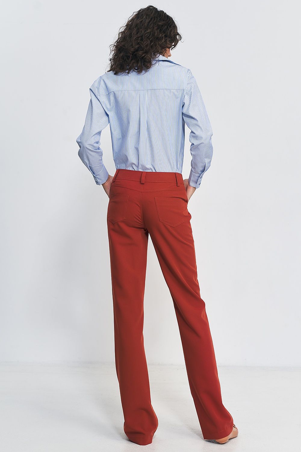 Nife bootcut trousers elegantly paired with a chic top, exemplifying timeless fashion and comfort for the modern woman.
