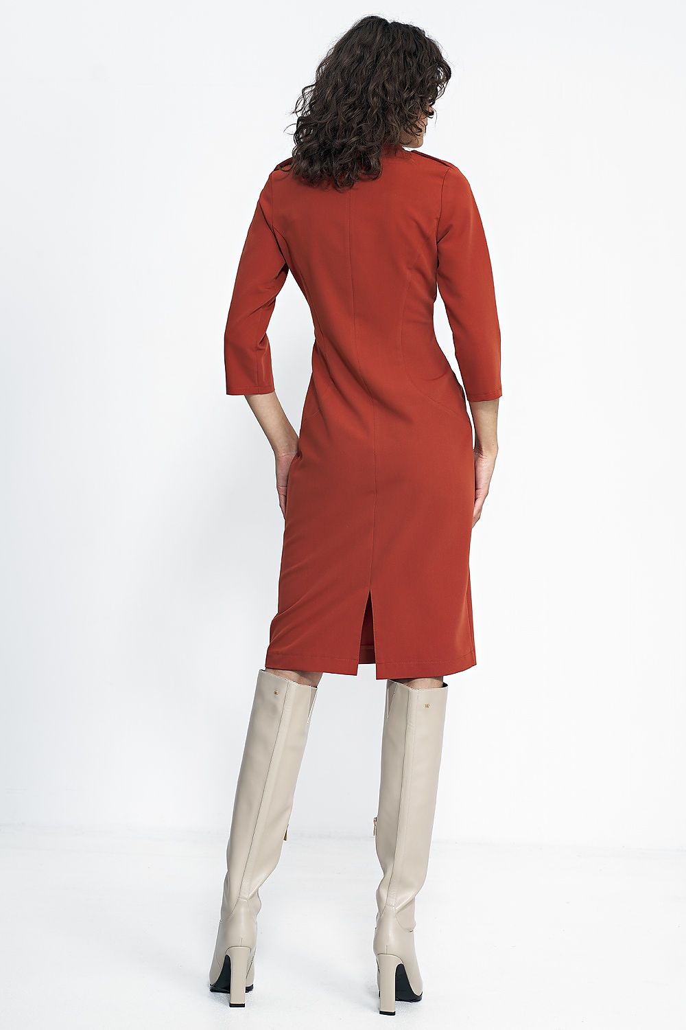 Elegant Nife Daydress styled with long boots, showcasing its tailored fit and sophisticated look, ideal for colder days in autumn.