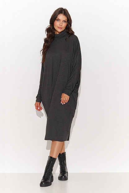 Close-up of the fabric and decorative blouse finish of the luxurious turtleneck daydress by Numinou, emphasizing the high-quality viscose knit material.