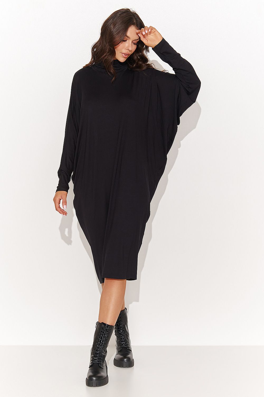 Elegant display of Numinou's oversized turtleneck daydress showcasing delicate creases and sophisticated design, perfect for various occasions.