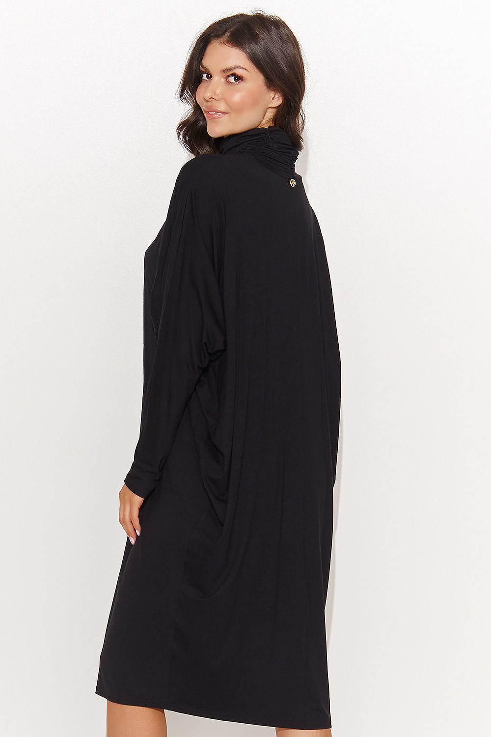 Graphite melange and black oversized turtleneck dress from Numinou, highlighting its versatility and chic appeal, ideal for pairing with stylish footwear.