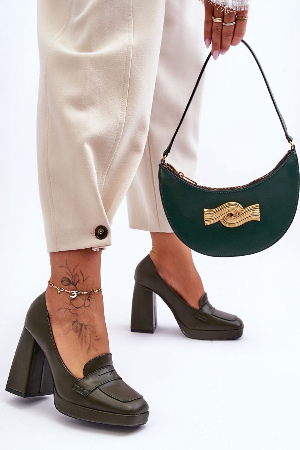 Chic green eco-leather heels from Step in Style, complemented by a stylish handbag, perfect for a sophisticated look.