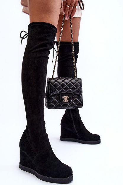 Elegant women's buskin boots by Step in style featuring a tied upper and side zipper, complemented by a stylish black quilted handbag, set against a minimalist white backdrop, showcasing the 9.5 cm heel and faux leather material.