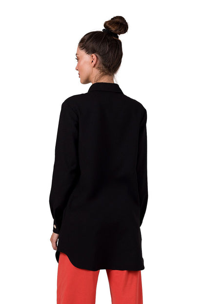 Model showcasing the BeWear tunic, designed in Poland, emphasizing long sleeves and button cuffs for an elegant silhouette.