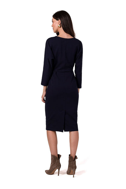 Side view of the BeWear Daydress showcasing its stylish slit at the back and luxurious knee-length design.