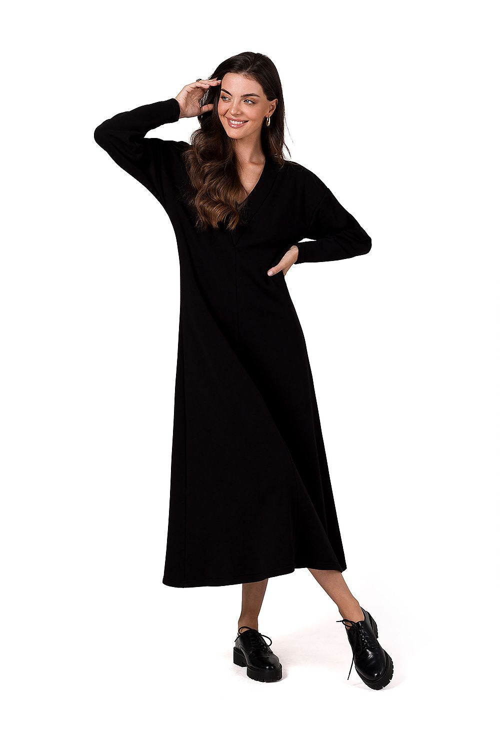 Luxurious BeWear maxi knitted dress featuring a deep V neckline and flared cut, elegantly designed for comfort with long sleeves, perfect for stylish occasions.
