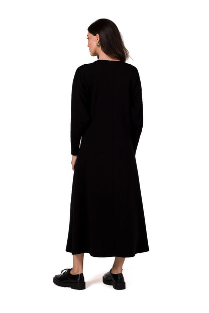 Sophisticated BeWear knitted maxi dress showcased in a stunning deep V neckline and stylish flared silhouette, ideal for chic autumn and winter looks.
